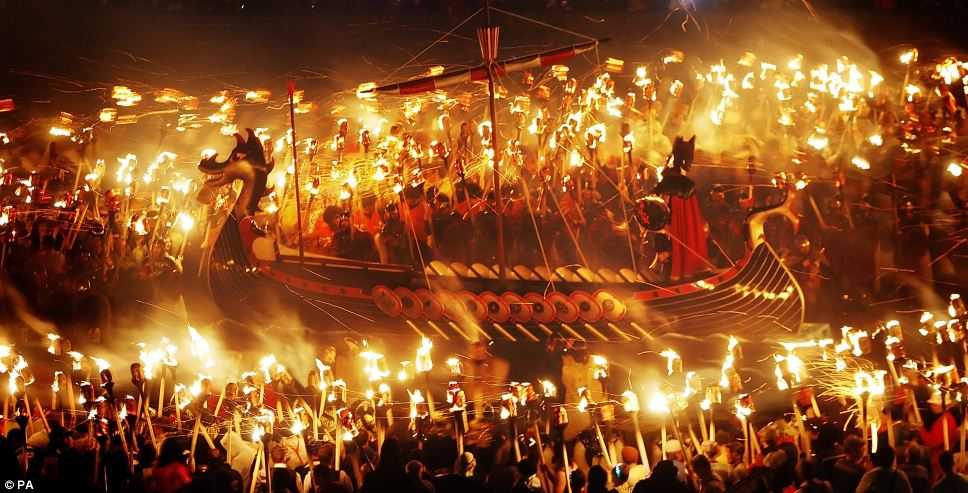 The galley surrounded by torch-bearing Vikings